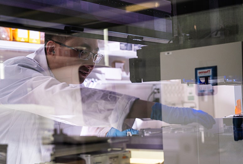 researcher interacting with lab equipment