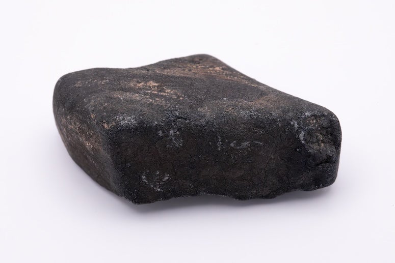 A black rock against a white background