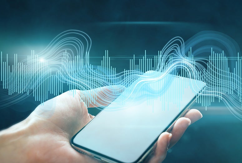Sound waves over hand holding a smartphone