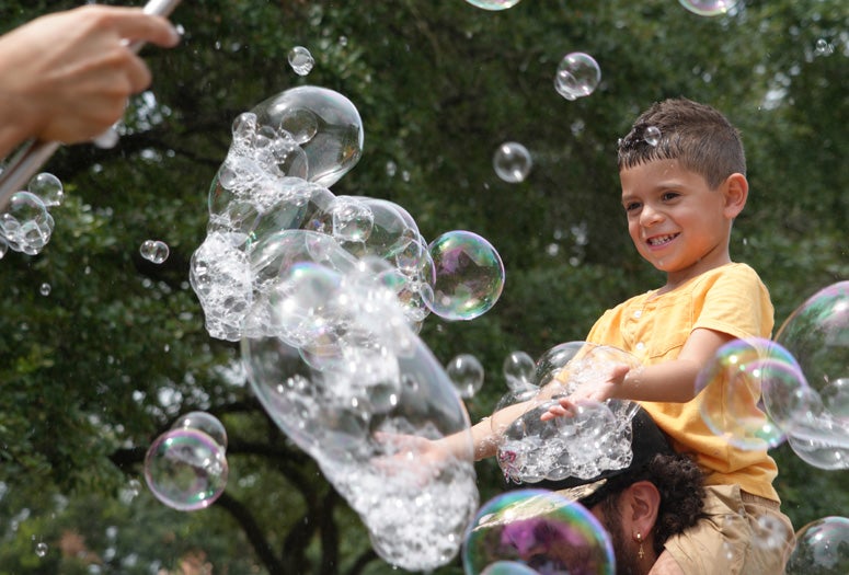Boy hunting bubbles at the Moody Center for the Arts' Summer Jam 2026