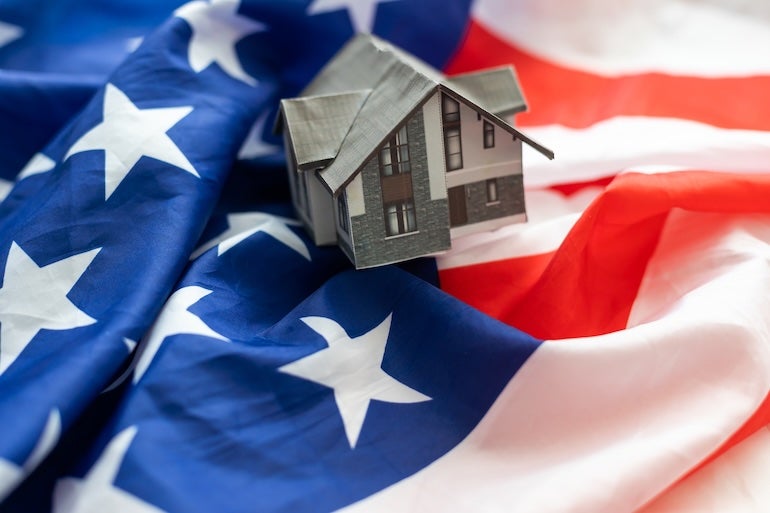 American flag with small house - homeownership