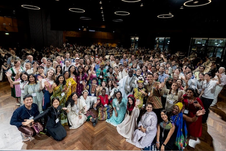 A large group of people dressed in various culture's traditional outfits