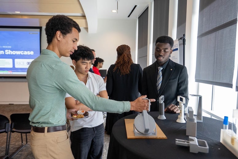 Students from the SEED program show off their designs. 