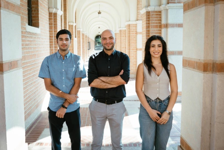 Farshid Alambeigi, center, with graduate students Daniyal Maroufi (left) and Mobina Tavangarifard (right). 