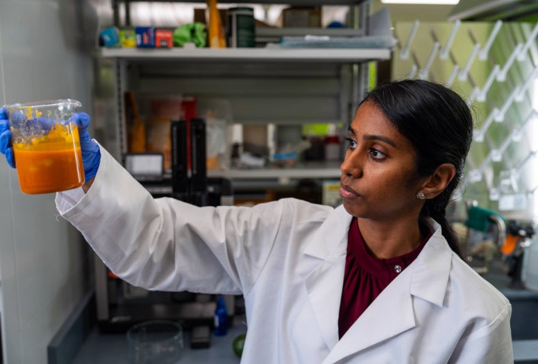 Neethu Pottackal examines a sample of NIVERA’s food coating 