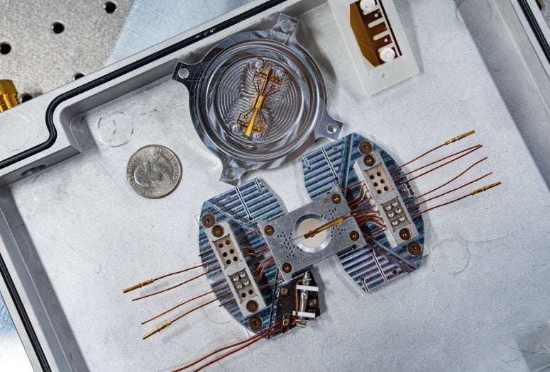 A trapped ion simulator on a metal tray