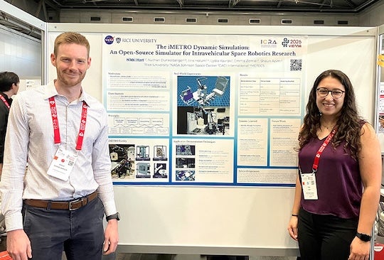 researchers stand on either side of research poster