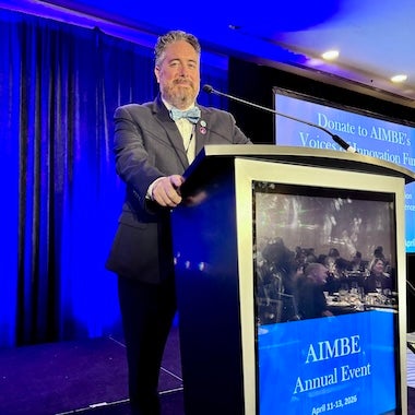 man standing behind a podium