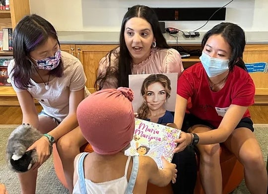 Lucia Noto reading to group of children