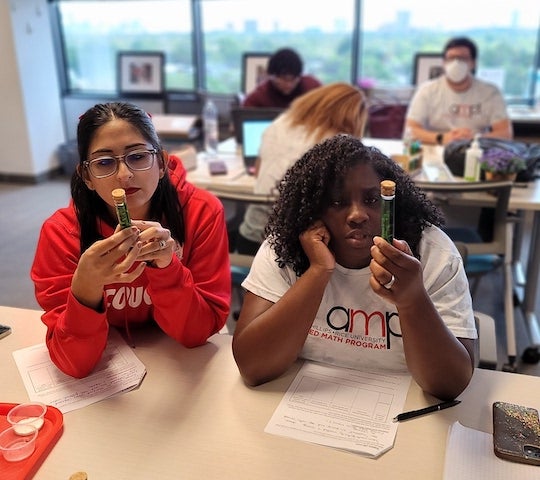 Teachers in the Rice University-based Applied Mathematics Program focus on an experiment in a STEM teacher training class