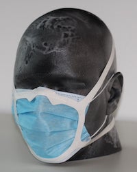 A silicone harness developed at Rice University, attached with an adhesive to a standard surgical mask, greatly improved the mask’s ability to keep airborne droplets out. 