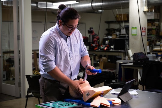 Bioengineering senior Reed Corum demonstrates his team’s laryngoscope on a manikin at Rice University’s Oshman Engineering Design Kitchen. (Credit: Jeff Fitlow/Rice University)