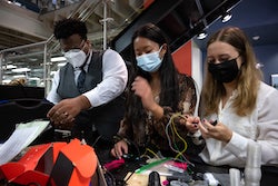 From left, Rice University senior bioengineering students David Ikejiani, Victoria Kong and Rebecca Franklin work on the camera mount for their wireless laryngoscope. The device, created as their required capstone project, will simplify the process of intubating patients. (Credit: Jeff Fitlow/Rice University)