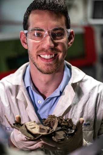 Rice University graduate student Kevin Wyss holds untreated parts from an “end-of-life” truck that would be ground into powder and turned into graphene via the lab’s flash Joule heating process. The graphene can then be repeatedly recycled to provide enhanced strength and sound-dampening polyurethane for new vehicles. 