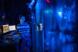 To compare the speed of charge and spin waves, Rice University physicist Danyel Cavazos and colleagues built a quantum simulator that uses ultracold lithium atoms as stand-ins for electrons and a channel of light in place of a 1D electronic wire. (Photo by Jeff Fitlow/Rice University)
