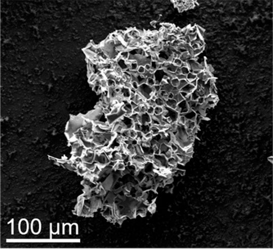 Pores in this micron-scale particle, the result of pyrolyzing in the presence of potassium acetate, are able to sequester carbon dioxide from streams of flue gas. Rice University scientists say the process could be a win-win for a pair of pressing environmental problems. (Credit: Tour Group/Rice University)