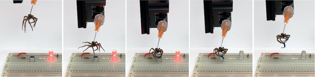 A gripper is used to lift a jumper and break a circuit on an electronic breadboard, turning off an LED. Courtesy of the Preston Innovation Laboratory