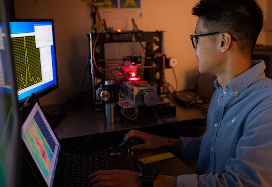 Graduate student Wei Meng works at a test rig at a Rice University lab, validating measurements of strain in a variety of materials with strain-sensing smart skin. Photo by Jeff Fitlow