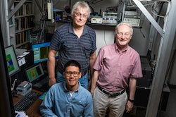 Rice University researchers Wei Meng (seated), Sergei Bachilo (left) and Bruce Weisman developed strain-sensing smart skin based on Weisman’s pioneering discovery of fluorescence in carbon nanotubes. They worked with Rice structural engineer Satish Nagarajaiah to develop the non-contact method to efficiently measure strain in large structures. (Credit: Jeff Fitlow/Rice University)