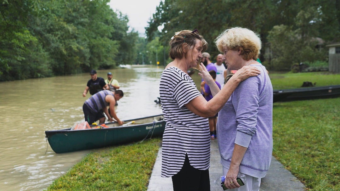 Neighbors comfort one another Aug. 30, 2017, during Hurricane Harvey’s catastrophic flooding in Humble, Texas, north of Houston. Harvey inundated more than 200,000 homes in the city of Houston and tens of thousands more in a 41-county area of southeast Texas. (Photo by Brandon Martin/Rice University)