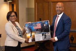 Vanessa Wyche, director of NASA’s Johnson Space Center, and Rice University President Reginald DesRoches signed an extension of the long-standing Space Agreement Act between the institutions on Aug. 19. Here, Wyche presents a plaque to DesRoches that incorporates an American flag flown on the SpaceX Crew-1 mission, which included astronaut and Rice alumna Shannon Walker. (Credit: Jeff Fitlow/Rice University)