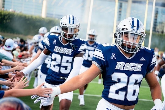 Rice football team runs onto the field