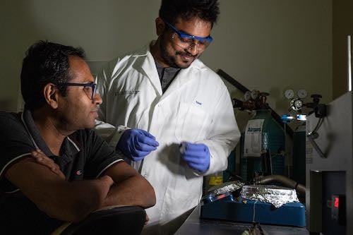 Rice University materials scientist Muhammad Rahman, left, and graduate student M.A.S.R. Saadi prepare a sulfur-selenium compound for testing as an anti-corrosion agent for steel. (Credit: Jeff Fitlow/Rice University) 