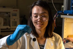 Rice University postdoctoral researcher Xu Zhang prepares a water sample for testing with programmable bacteria that test for contaminants and release an electronic signal for detection in real time. (Credit: Brandon Martin/Rice University)