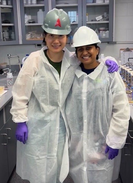 Rice University graduate students Esther Lou, left, and Priyanka Ali are dressed for success as they embark upon testing of wastewater samples they collected at a Houston-area treatment plant. 