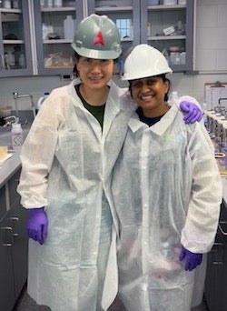 Rice University graduate students Esther Lou, left, and Priyanka Ali are dressed for success as they embark upon testing of wastewater samples they collected at a Houston-area treatment plant. The students are co-authors of a study that determined wastewater “snapshots” lead to bias in testing for the presence of antibiotic resistant genes compared to daylong composite samples. (Credit: Stadler Research Group/Rice University)
