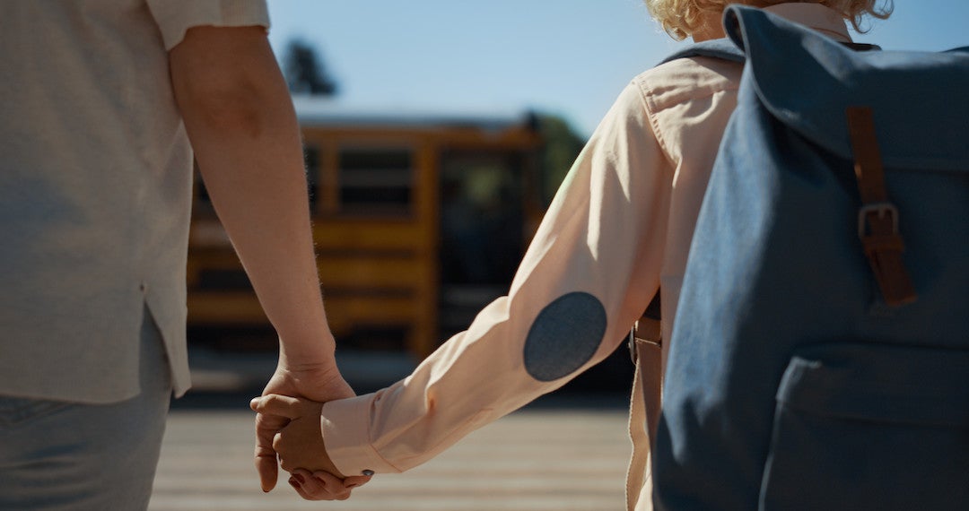 Photo of parent and child holding hands