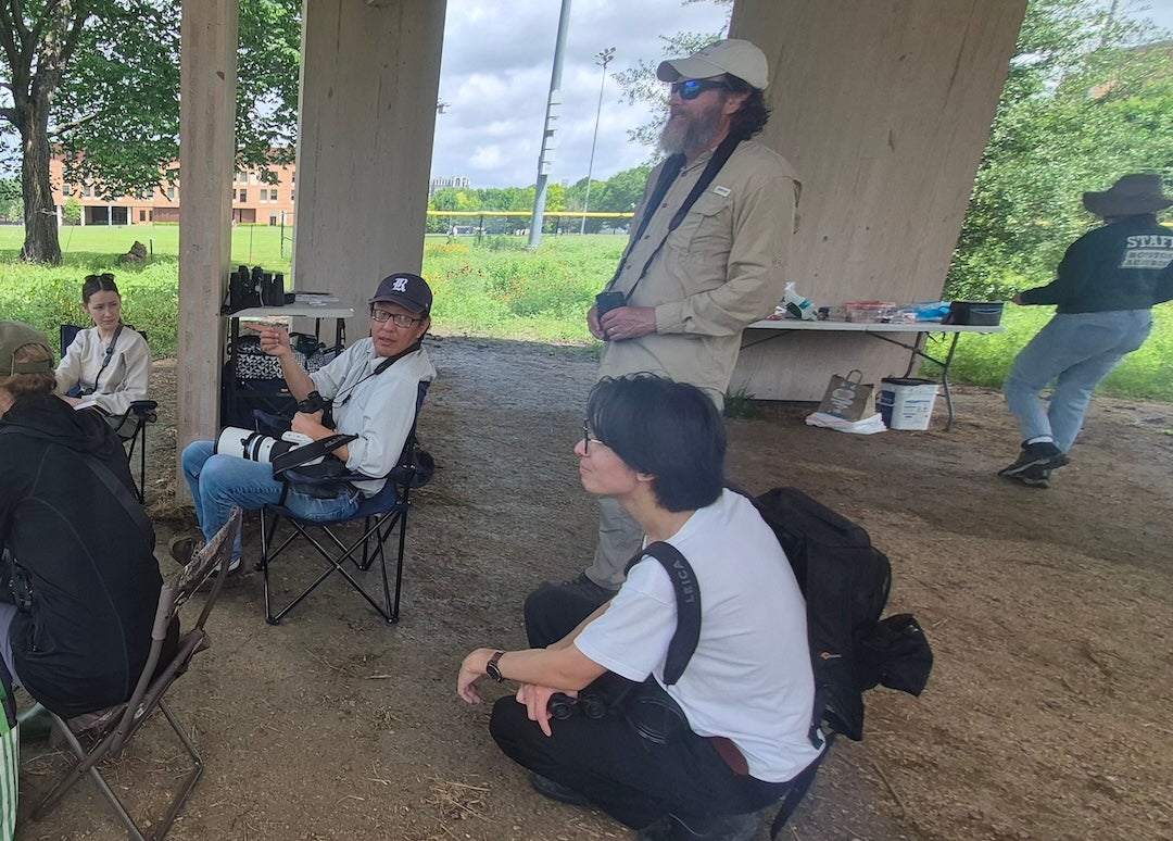 A group of people are in a pavilion. 