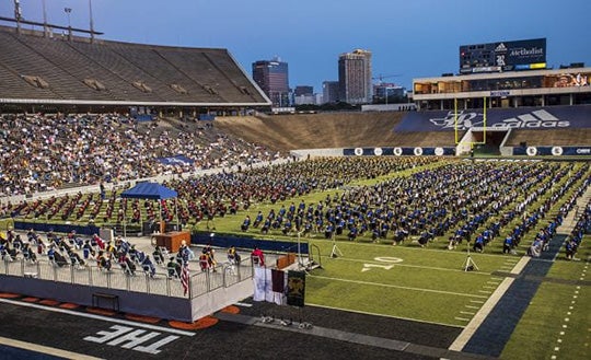 Rice Stadium with graduates at commencement