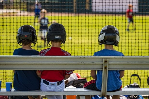 Children sitting watching baseball 