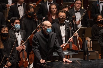 Larry Rachleff and members of the orchestra stand following the performance. 