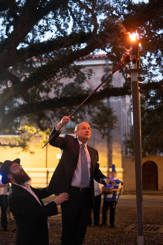 President Leebron lights the menorah