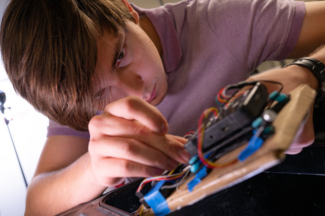 Christopher Conway works on the drone's circuitry