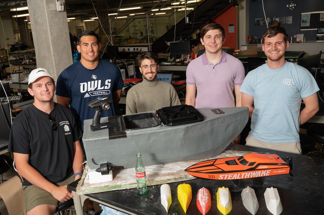 Engineering design team Coke Boat Crackdown posing with marine drone device