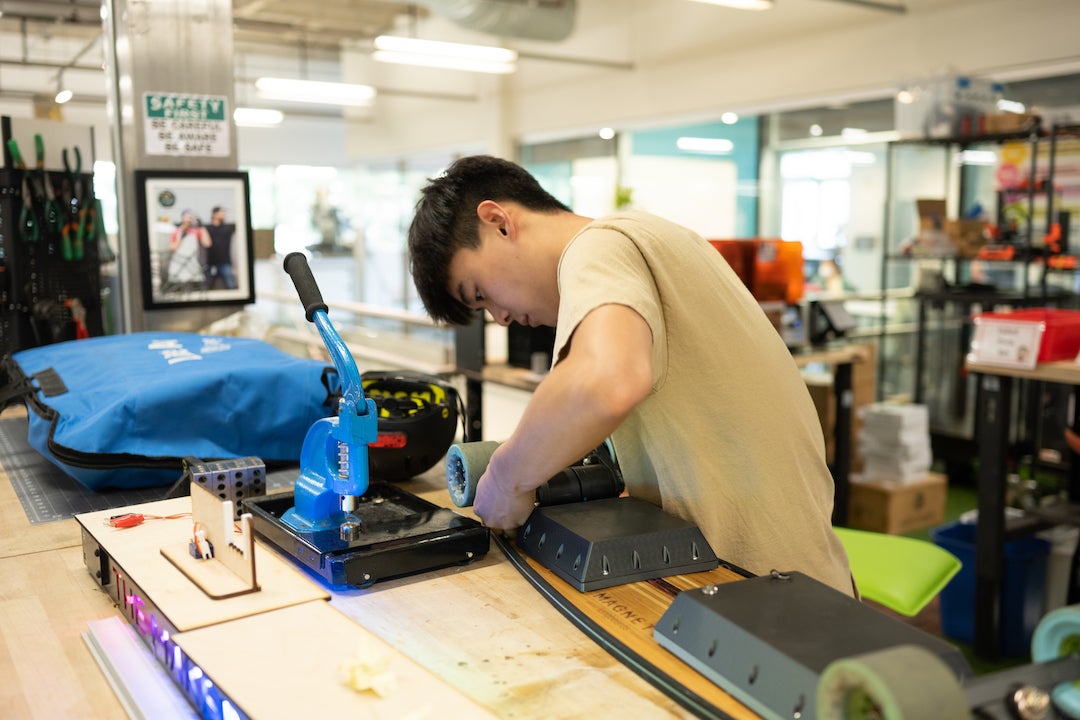 Chris Hong works on the board