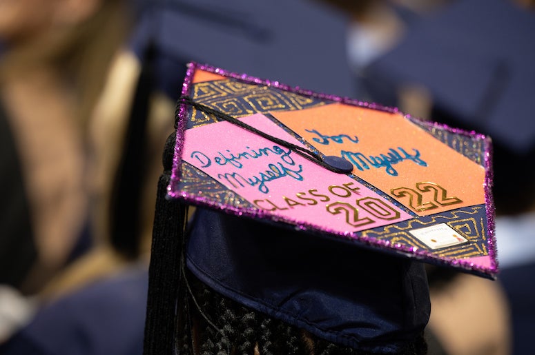 Candidates for advanced degrees sported mortarboards with messages at their investiture May 6 in Tudor Fieldhouse.