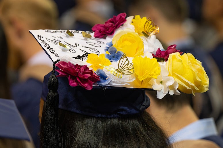 Candidates for advanced degrees sported mortarboards with messages at their investiture May 6 in Tudor Fieldhouse.