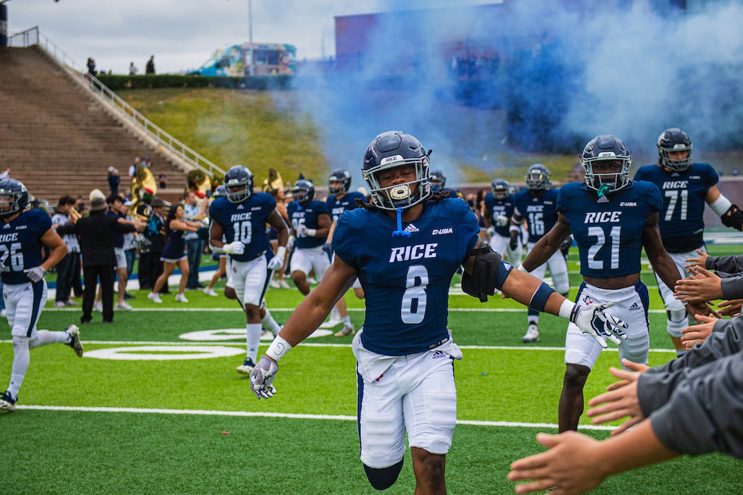 Rice football players enter field at Owl Together 2022 homecoming football game