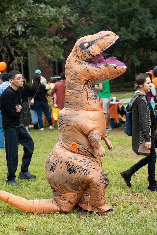 Person in inflatable tyrannosaurus rex costume at Project Pumpkin 2022