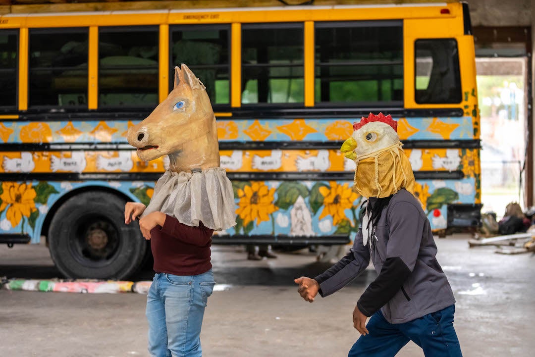 Performers in masks at Bread and Puppet workshop