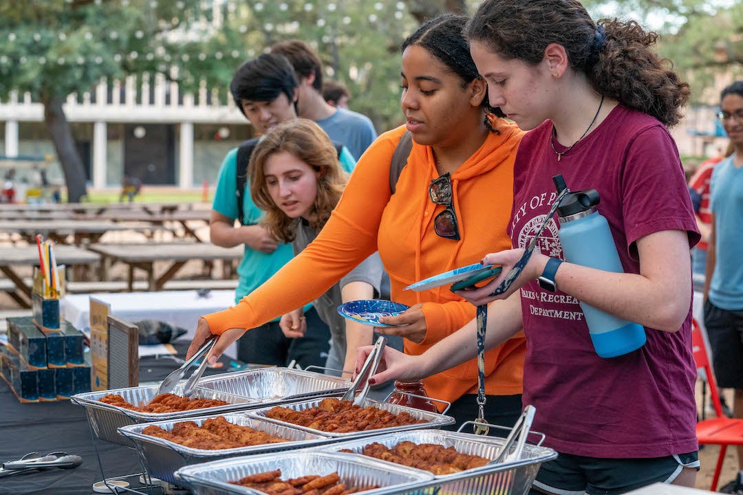 Students getting free latkes at pre-Hannukah party