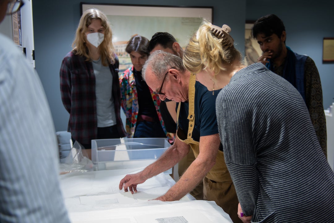 Renowned William Blake scholar and printmaker Michael Phillips shows students the printmaking process during a showcase of the newly-acquired star-wheel copper-plate rolling press at the Woodson Research Center in Fondren Library on March 1, 2023.