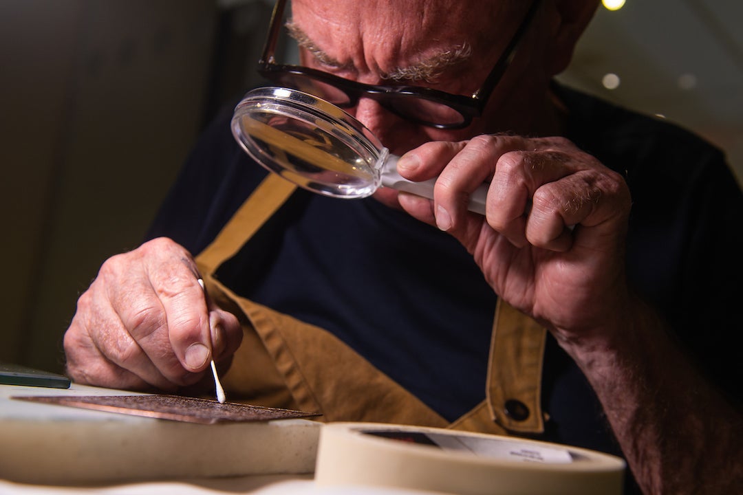 Renowned William Blake scholar and printmaker Michael Phillips shows students the printmaking process during a showcase of the newly-acquired star-wheel copper-plate rolling press at the Woodson Research Center in Fondren Library on March 1, 2023.