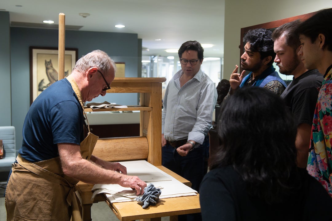 Renowned William Blake scholar and printmaker Michael Phillips shows students the printmaking process during a showcase of the newly-acquired star-wheel copper-plate rolling press at the Woodson Research Center in Fondren Library on March 1, 2023.