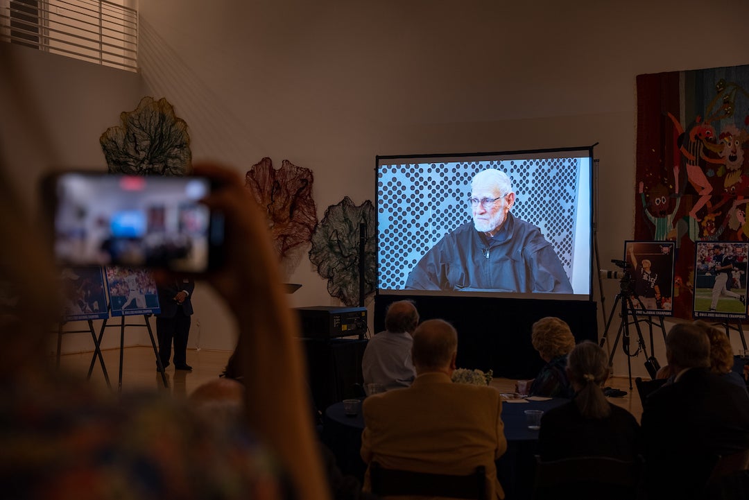 A video message from former Rice baseball head coach Wayne Graham is played at the 20-year championship anniversary event.