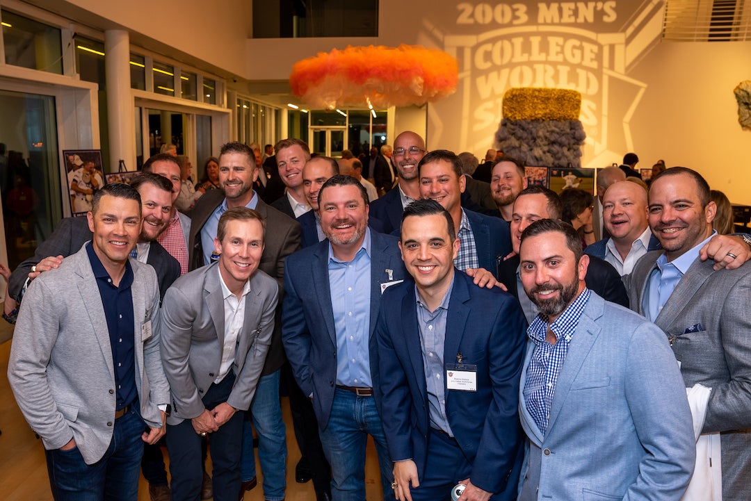 Members of the 2003 Rice baseball team pose for a photo at the March 24 championship celebration event.